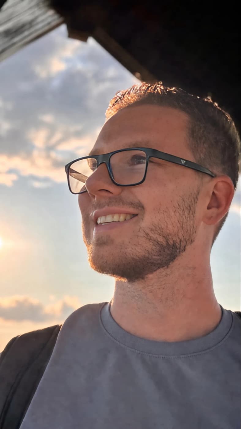 Tadeáš smiling and looking up at an evening sky